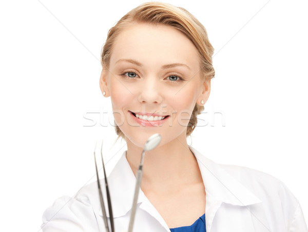 attractive female dentist with tools Stock photo © dolgachov