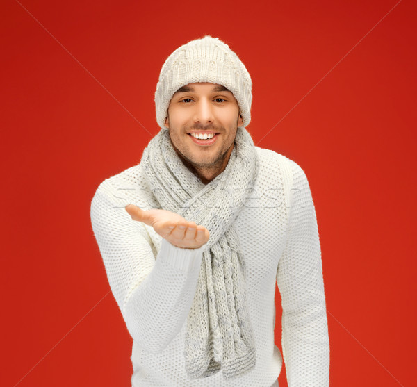 handsome man with something on the palm Stock photo © dolgachov