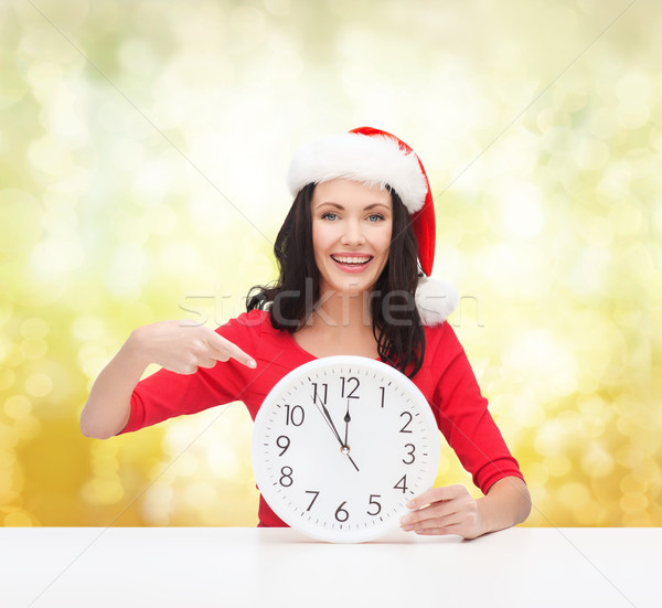 Kobieta Święty mikołaj pomocnik hat zegar Zdjęcia stock © dolgachov