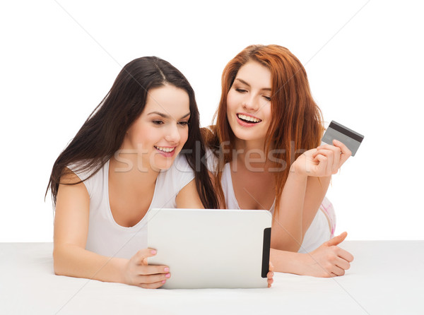 smiling teenagers with tablet pc and credit card Stock photo © dolgachov