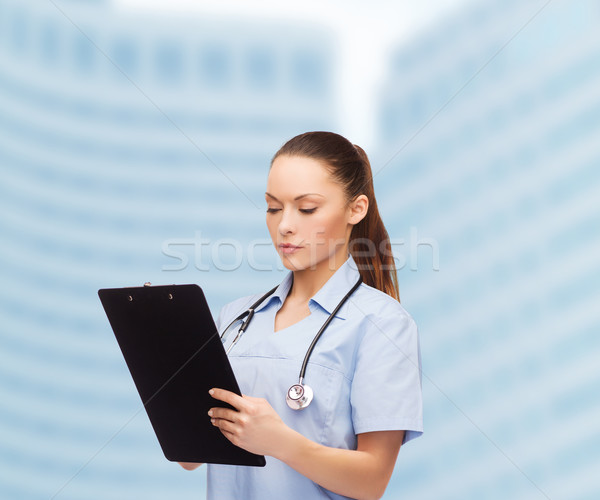 serious female doctor or nurse with stethoscope Stock photo © dolgachov