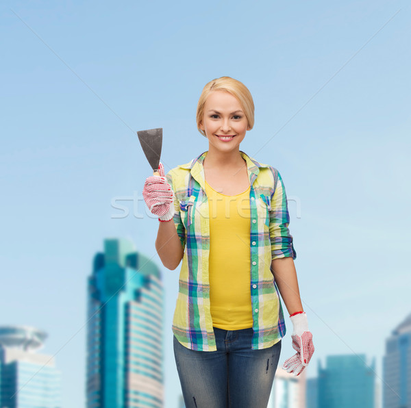 smiling female worker in gloves with spatula Stock photo © dolgachov