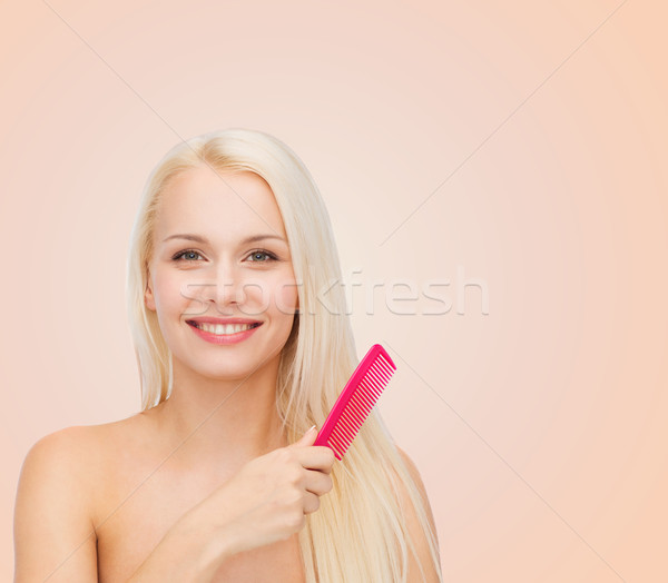 smiling woman with hair brush Stock photo © dolgachov