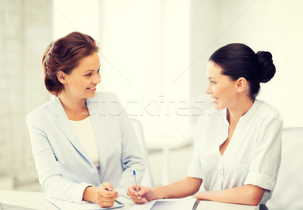 two businesswomen having discussion in office Stock photo © dolgachov