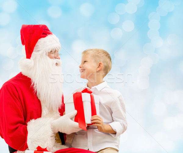 smiling little boy with santa claus and gifts Stock photo © dolgachov