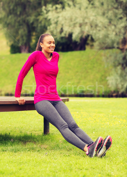 улыбающаяся женщина скамейке улице фитнес спорт Сток-фото © dolgachov