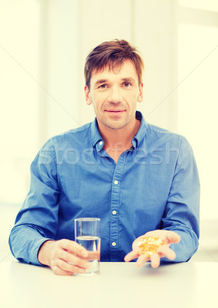 man at home showing lot of pills Stock photo © dolgachov