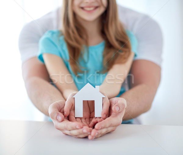 close up of man and girl hands with paper house Stock photo © dolgachov