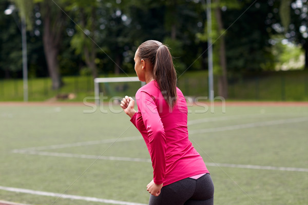 woman running on track outdoors from back Stock photo © dolgachov