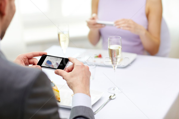 close up of couple with smartphones at restaurant Stock photo © dolgachov
