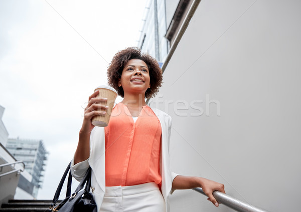 happy african businesswoman with coffee in city Stock photo © dolgachov