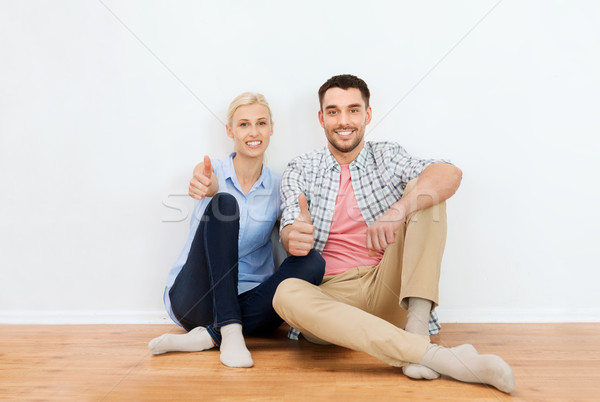 happy couple showing thumbs up at new home Stock photo © dolgachov