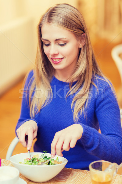 happy young woman having dinner at restaurant Stock photo © dolgachov