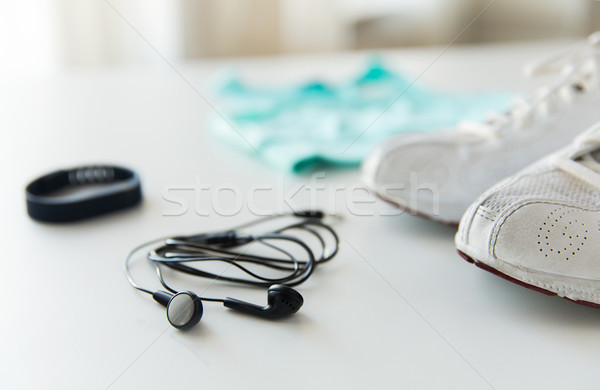 close up of earphones, bracelet and sportswear Stock photo © dolgachov