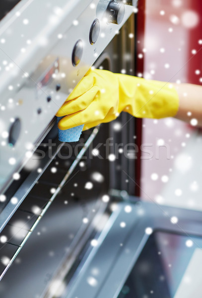 close up of woman cleaning oven at home kitchen Stock photo © dolgachov