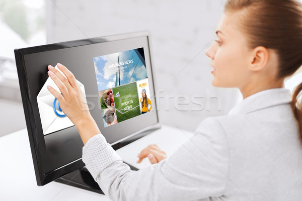 woman with web pages on touchscreen in office Stock photo © dolgachov