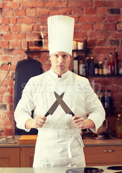 happy male chef cook in kitchen with knife Stock photo © dolgachov