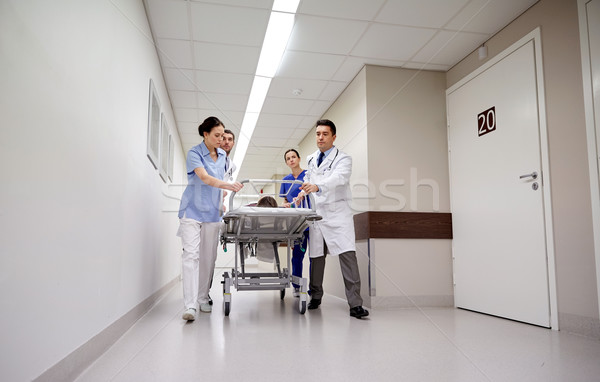 medics and patient on hospital gurney at emergency Stock photo © dolgachov
