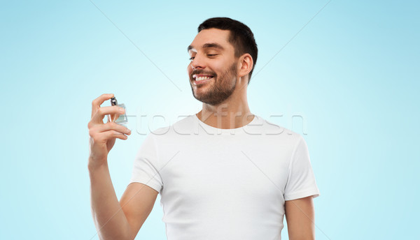 Uśmiechnięty człowiek mężczyzna perfum szary perfumeria Zdjęcia stock © dolgachov