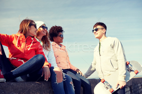 happy teenage friends with longboard on street Stock photo © dolgachov