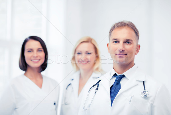 doctor with stethoscope and colleagues Stock photo © dolgachov