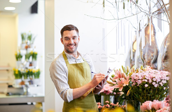 Fleuriste homme presse-papiers personnes vente Photo stock © dolgachov
