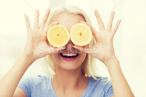 happy woman having fun covering eyes with lemon Stock photo © dolgachov