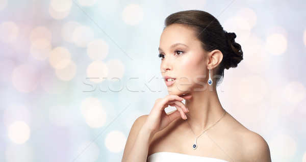 beautiful asian woman with earring and pendant Stock photo © dolgachov