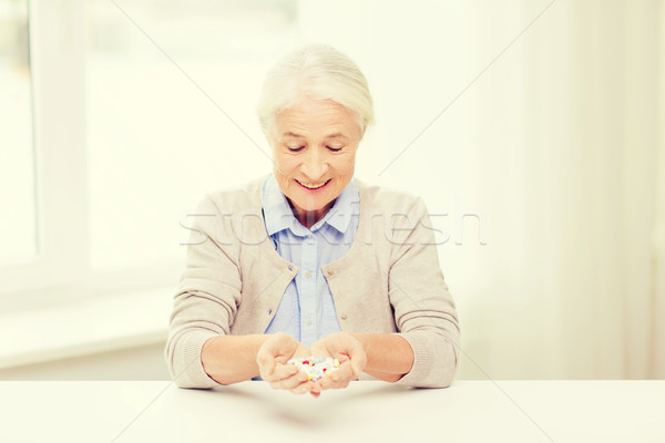 happy senior woman with medicine at home Stock photo © dolgachov