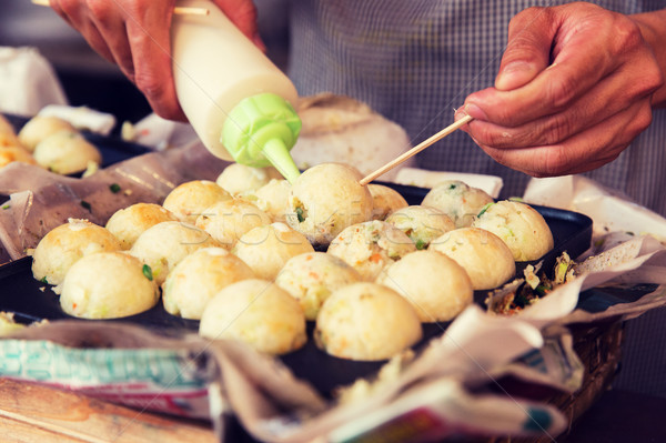 cook stuffing dough or rice balls at street market Stock photo © dolgachov