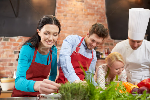 happy friends and male chef cooking in kitchen Stock photo © dolgachov