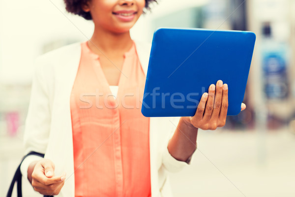 close up of african woman with tablet pc in city Stock photo © dolgachov