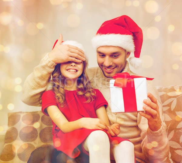 smiling father surprises daughter with gift box Stock photo © dolgachov