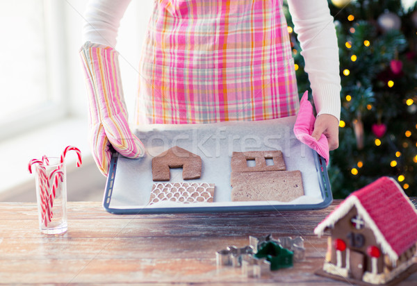 closeup of woman with gingerbread house on pan Stock photo © dolgachov