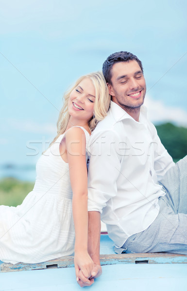 smiling couple at sea side Stock photo © dolgachov