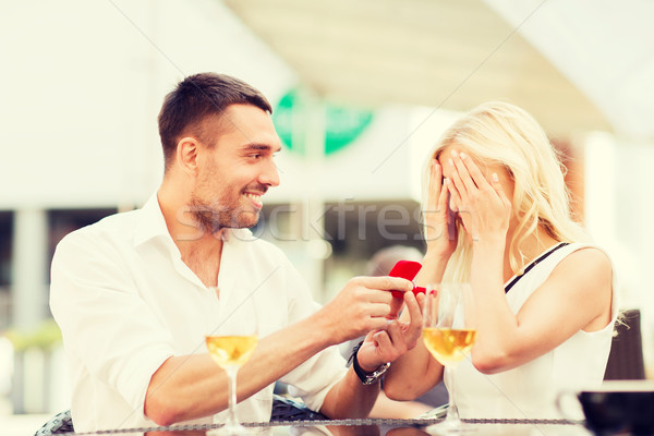 happy couple with engagement ring and wine at cafe Stock photo © dolgachov
