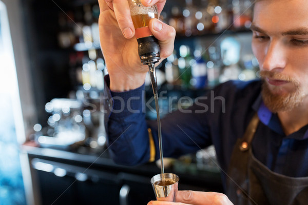 barman with shaker preparing cocktail at bar Stock photo © dolgachov