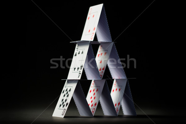 house of playing cards over black background Stock photo © dolgachov