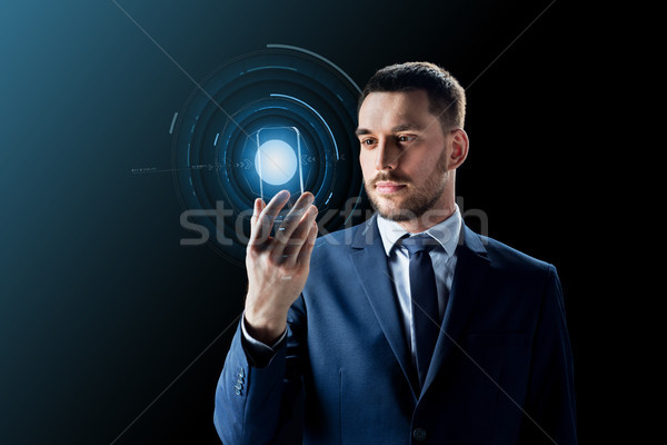 businessman with transparent smartphone Stock photo © dolgachov