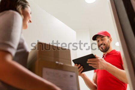 deliveryman and customer with parcel boxes at home Stock photo © dolgachov