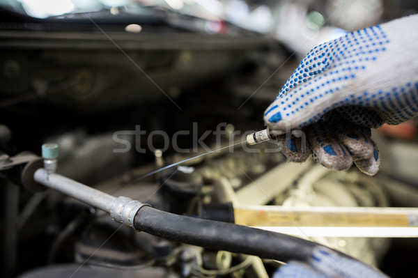 mechanic with dipstick checking motor oil level Stock photo © dolgachov