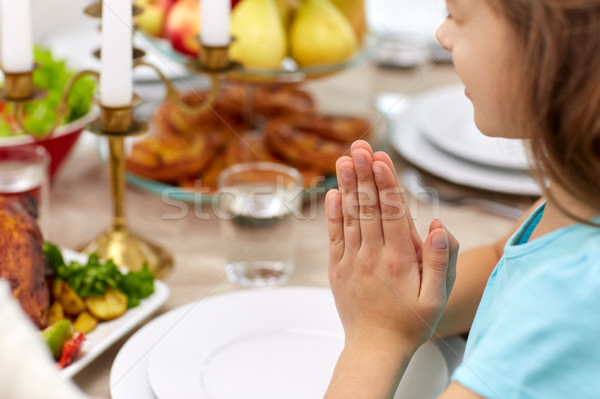 close up of girl having dinner and praying at home Stock photo © dolgachov