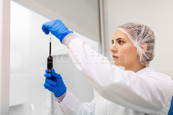 woman with sulphuric acid in dropper at laboratory Stock photo © dolgachov