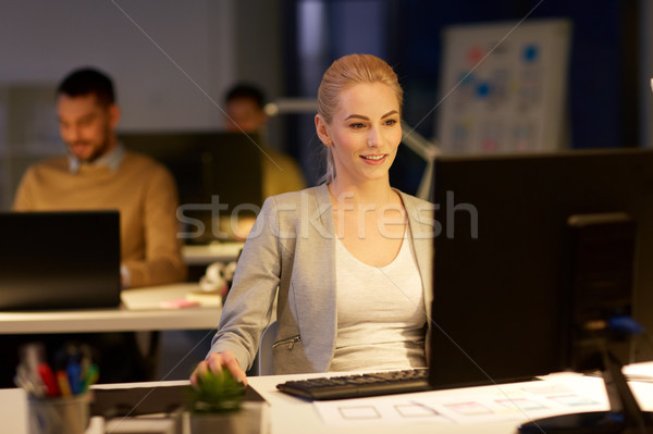 businesswoman at computer working at night office Stock photo © dolgachov