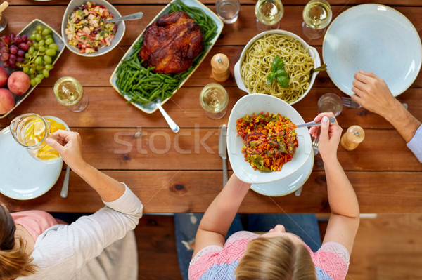 group of people eating at table with food Stock photo © dolgachov