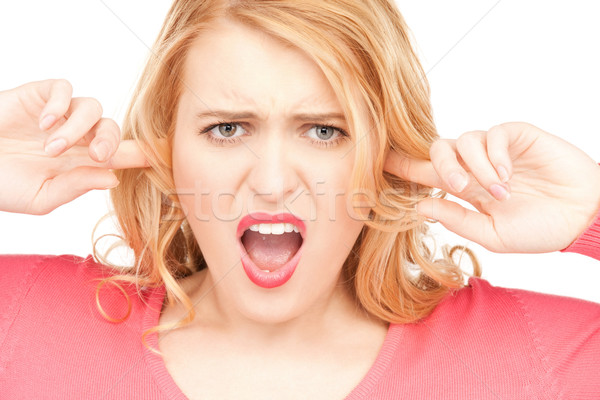 woman with fingers in ears Stock photo © dolgachov