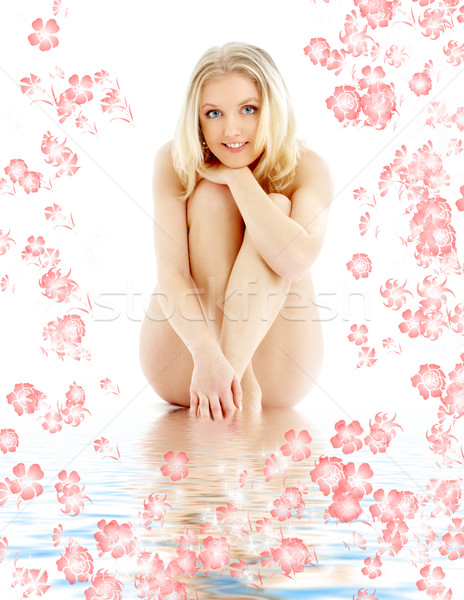 naked blond sitting in blue water with flowers Stock photo © dolgachov