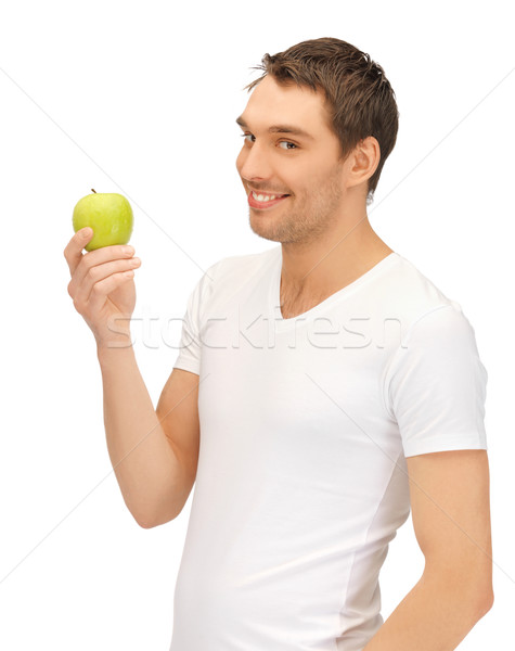 man in white shirt with green apple Stock photo © dolgachov