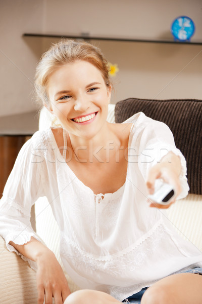 happy teenage girl with TV remote Stock photo © dolgachov