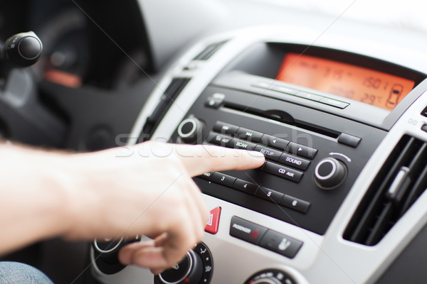 man using car audio stereo system Stock photo © dolgachov